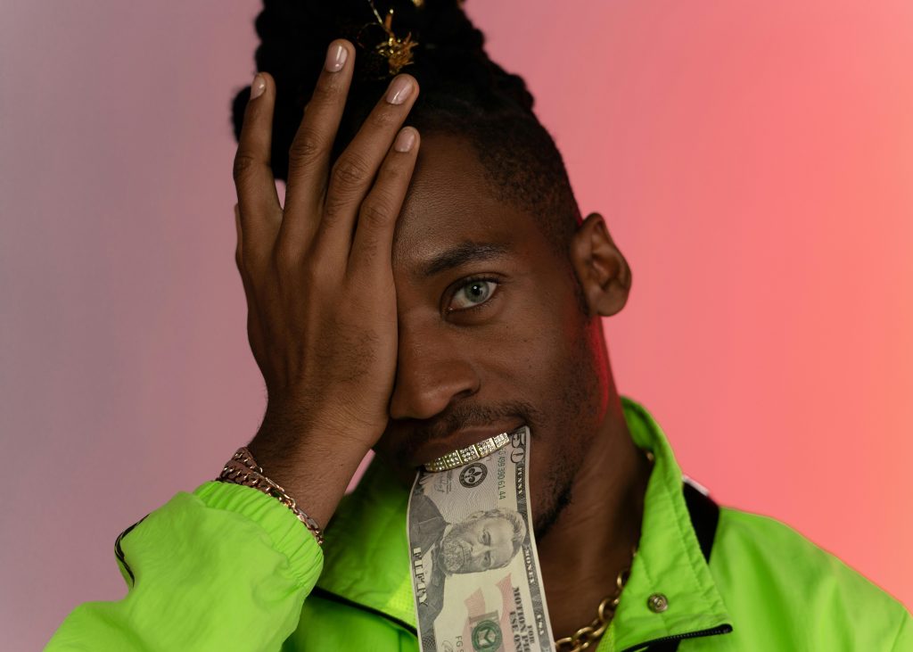 a rapper biting a dollar